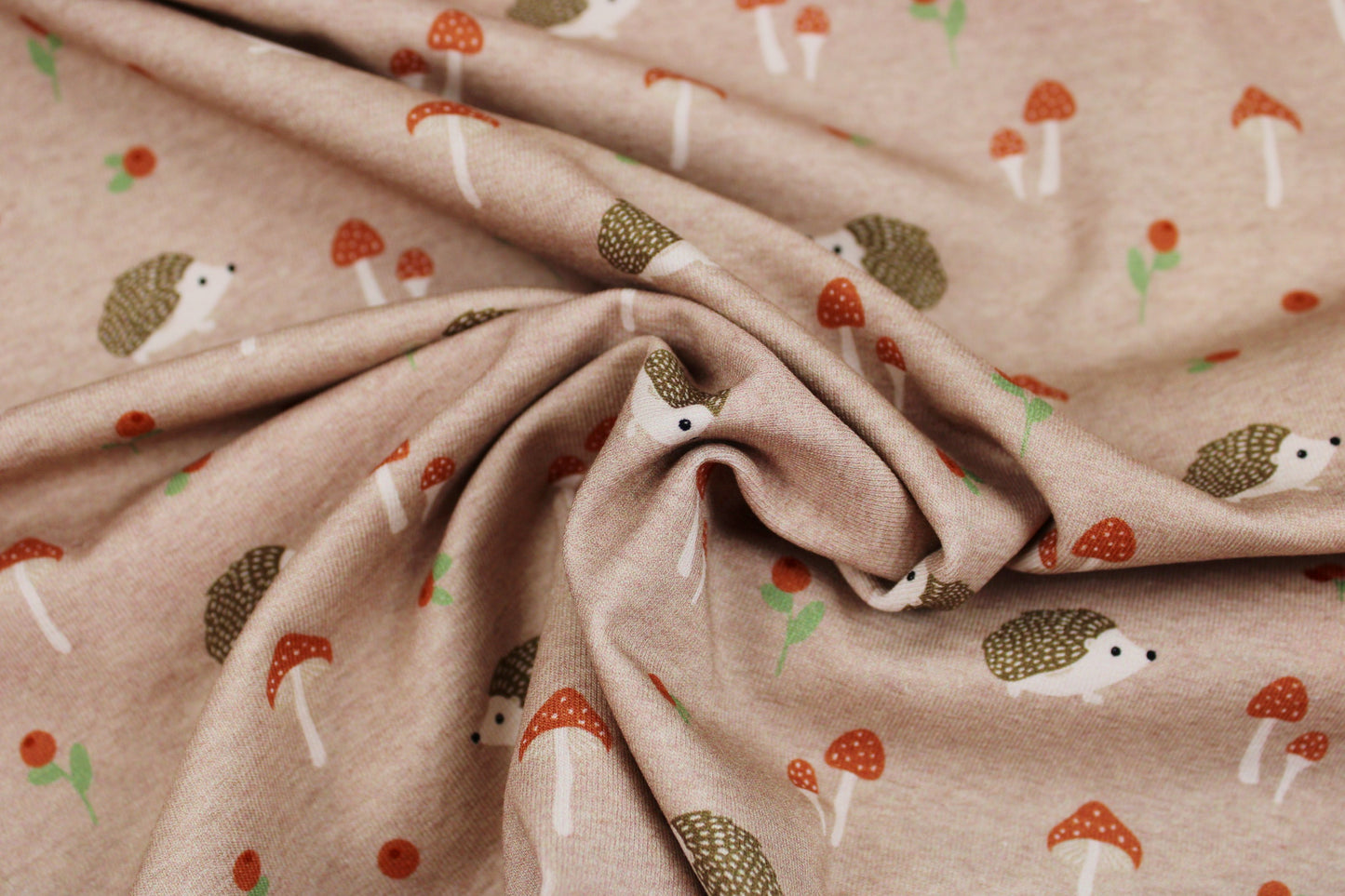 Baumwolljersey Aron mit kleinen Igeln und Pilzen auf Beige farbenem Grund gedreht