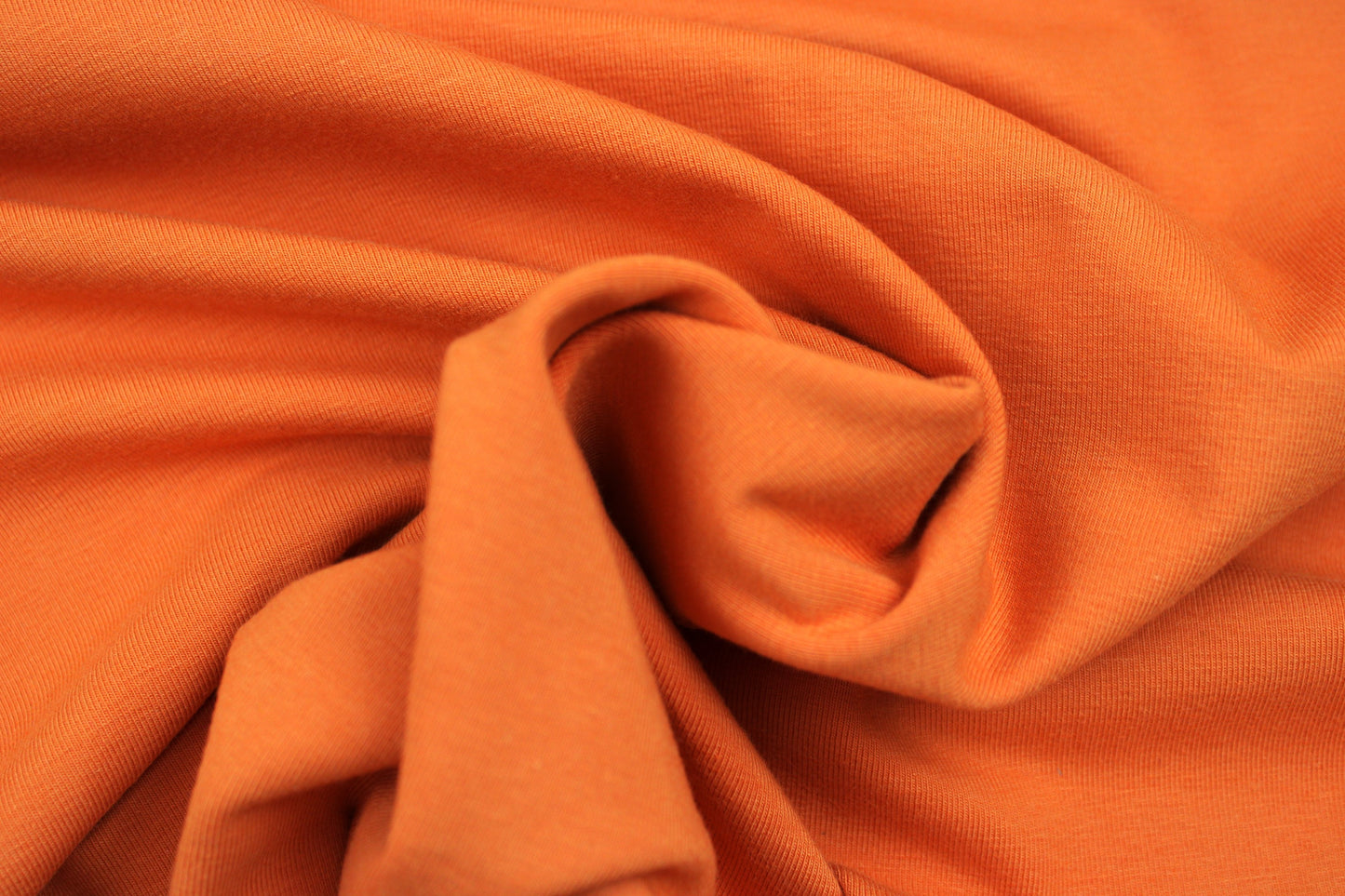 Baumwolljersey Vanessa in uni orange gedreht