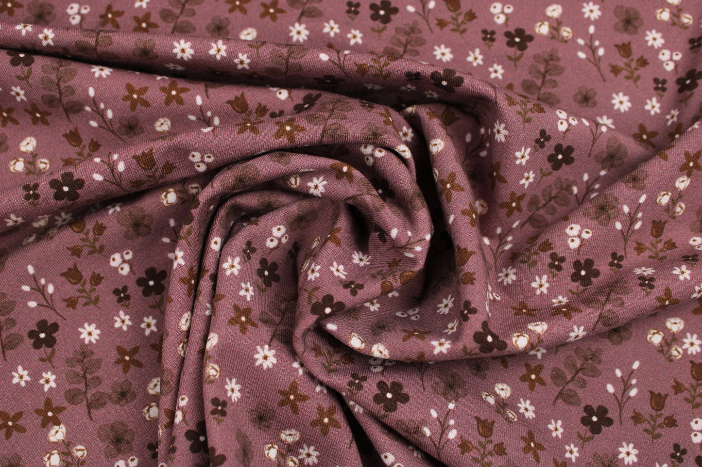 Dunkelrose farbener Baumwolljersey Winterbloom mit Streublümchen gedreht