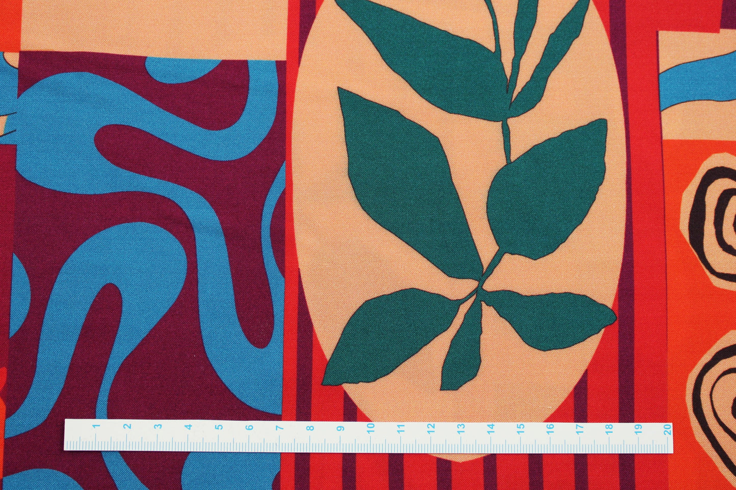 Weicher Viskosestoff mit rotem Patchworkprint Maßstab