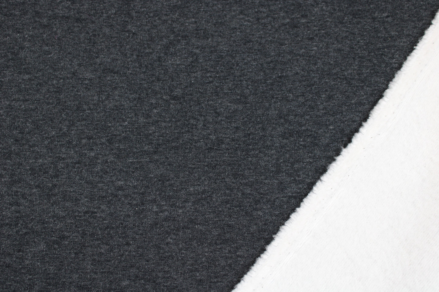 Melierter Alpenfleece Stoff in dunkelgrau mit weißer Fleeceabseite innen