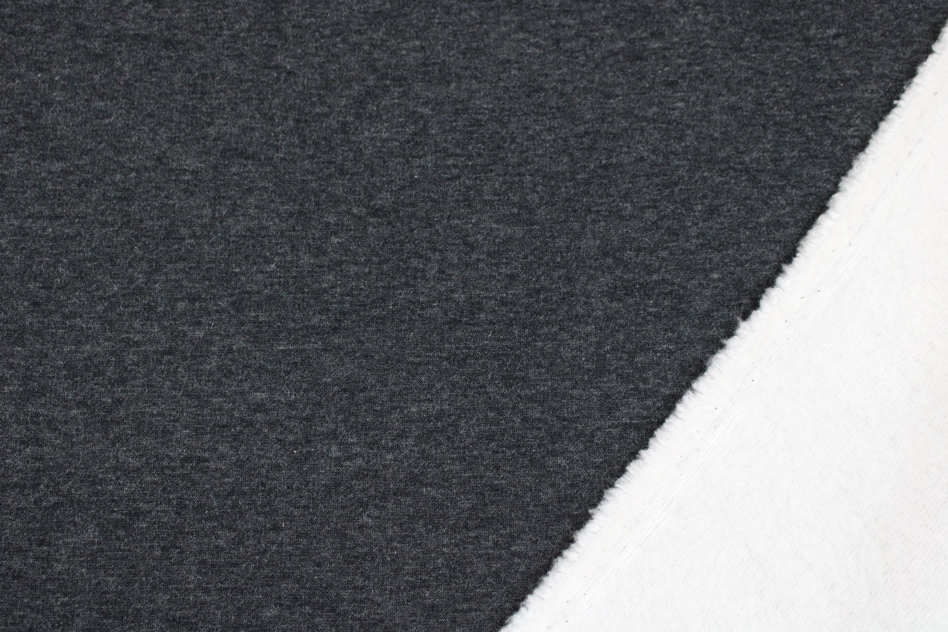 Melierter Alpenfleece Stoff in dunkelgrau mit weißer Fleeceabseite innen