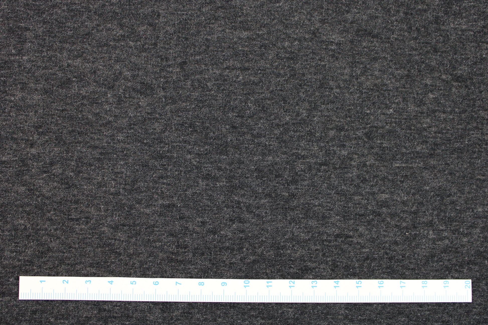 Melierter Alpenfleece Stoff in dunkelgrau mit weißer Fleeceabseite Maßstab