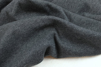 Melierter Alpenfleece Stoff in dunkelgrau mit weißer Fleeceabseite