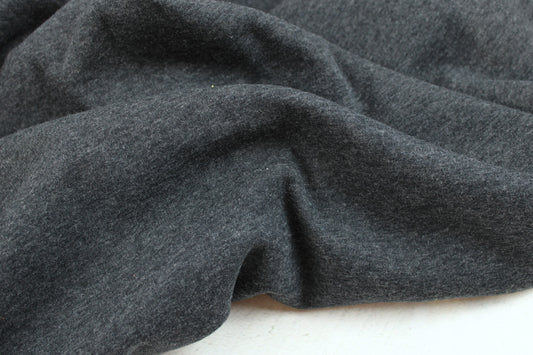 Melierter Alpenfleece Stoff in dunkelgrau mit weißer Fleeceabseite