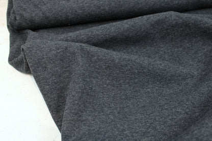 Melierter Alpenfleece Stoff in dunkelgrau mit weißer Fleeceabseite Ballenansicht