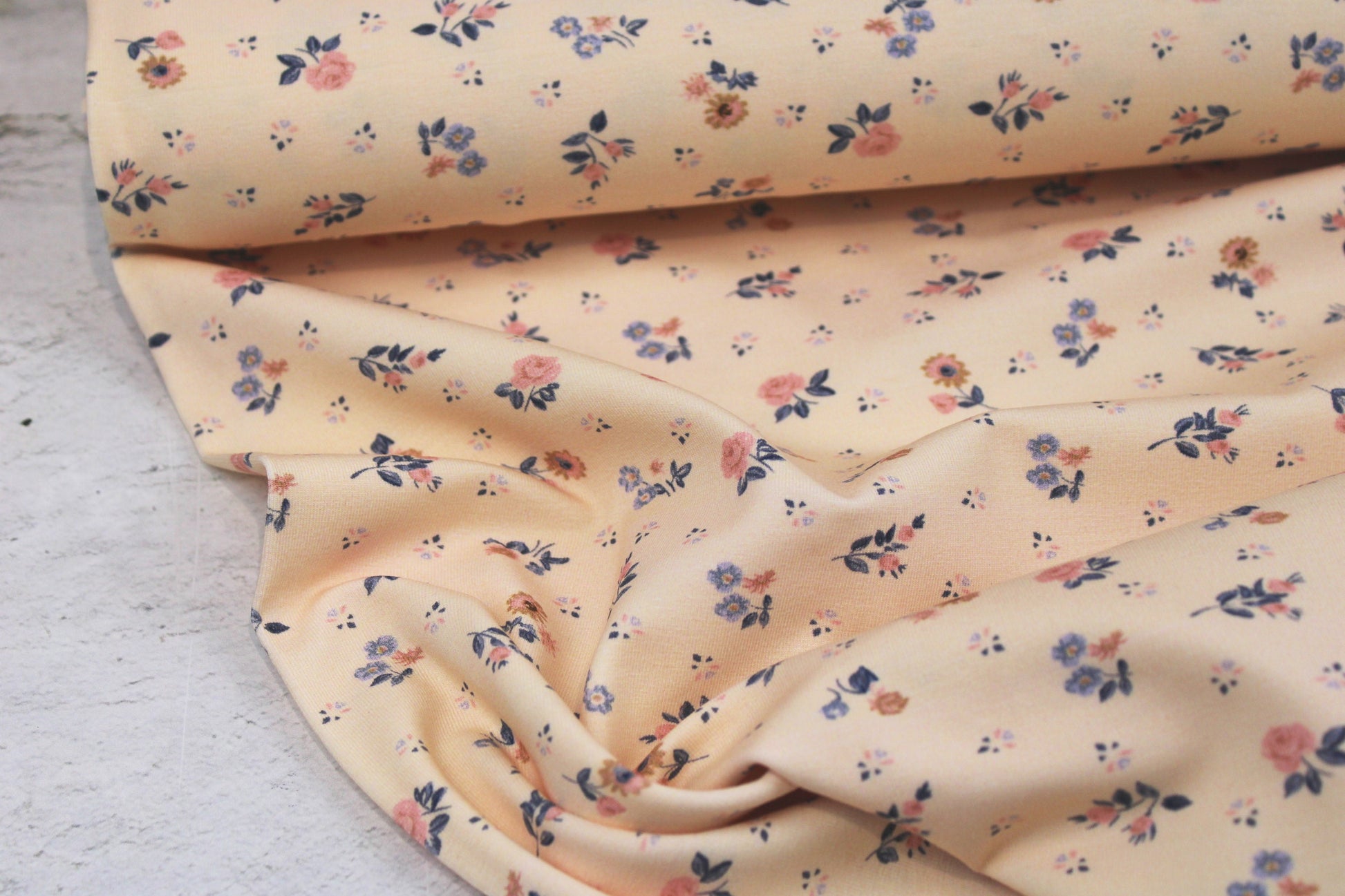 Baumwolljersey Flowers & Wood mit zarten Blümchen auf Creme farbenem Grund Ballenansicht