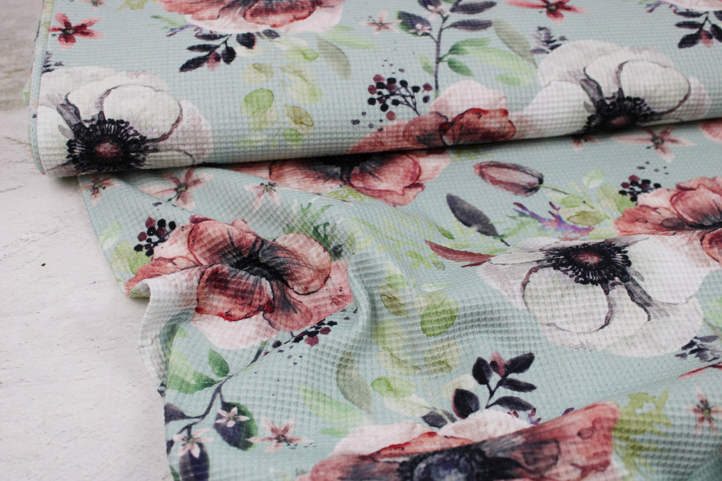 Waffelersey Lisa mit Blumenmuster auf mint farbenem Grund Ballenansicht