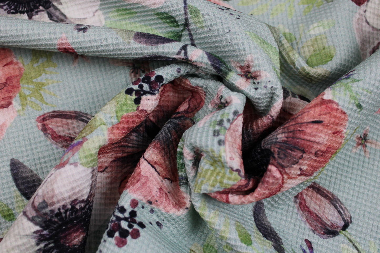 Waffelersey Lisa mit Blumenmuster auf mint farbenem Grund gedreht