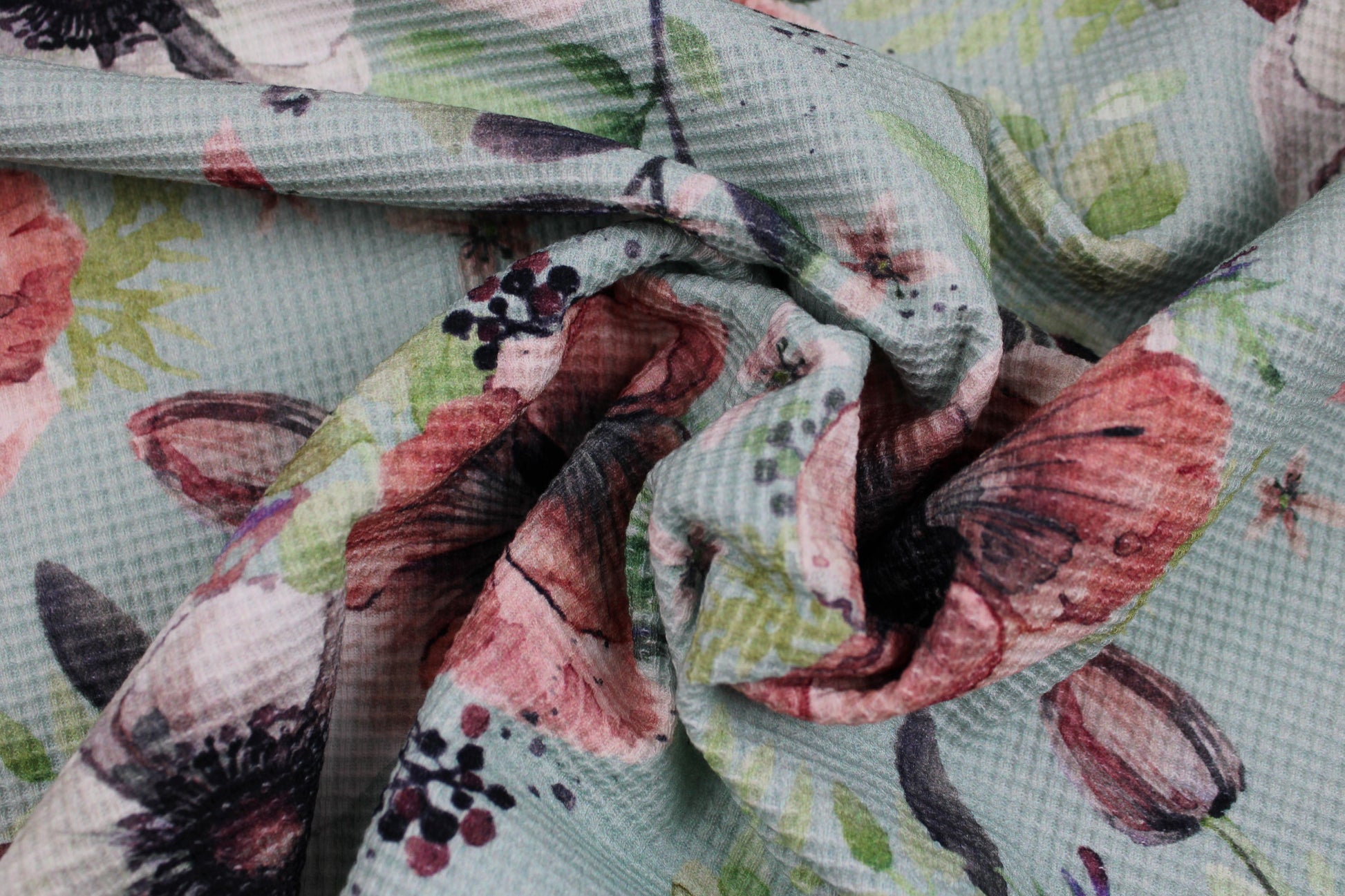 Waffelersey Lisa mit Blumenmuster auf mint farbenem Grund gedreht