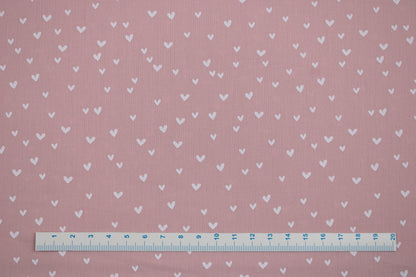 Rosa farbener Baumwollstoff Mini Heart mit kleinen weißen Herzen Maßstab