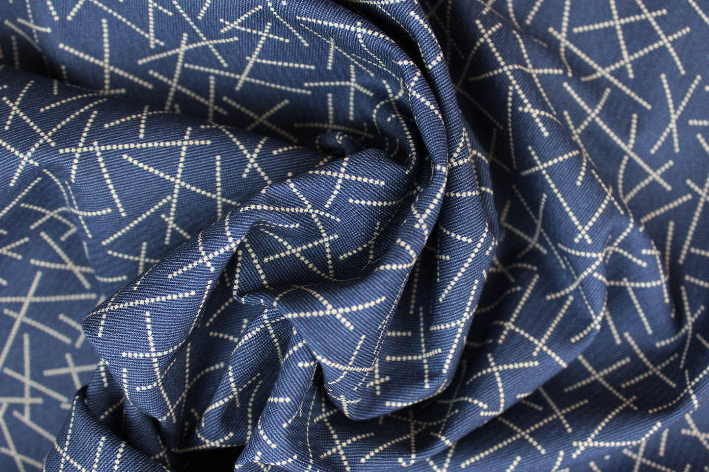Blauer Baumwollstoff mit hellem Linienmuster gedreht