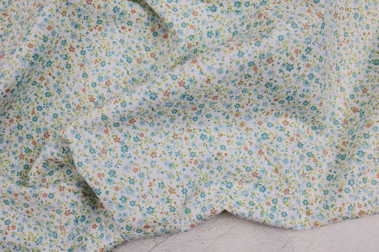 Baumwollstoff Minis mit kleinen Blümchen in Hellblau auf weißem Grund