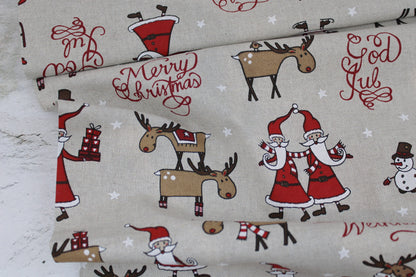 Canvasstoff Emil mit fröhlichen Weihnachtsmotiven auf beigem Grund Ballenansicht