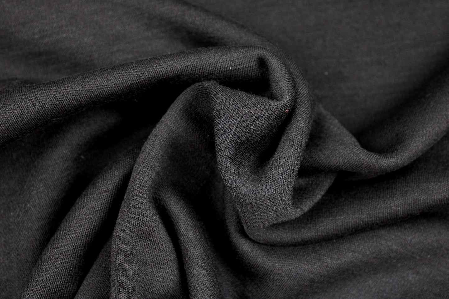 Merinostrickstoff Wolljersey in uni Schwarz gedreht