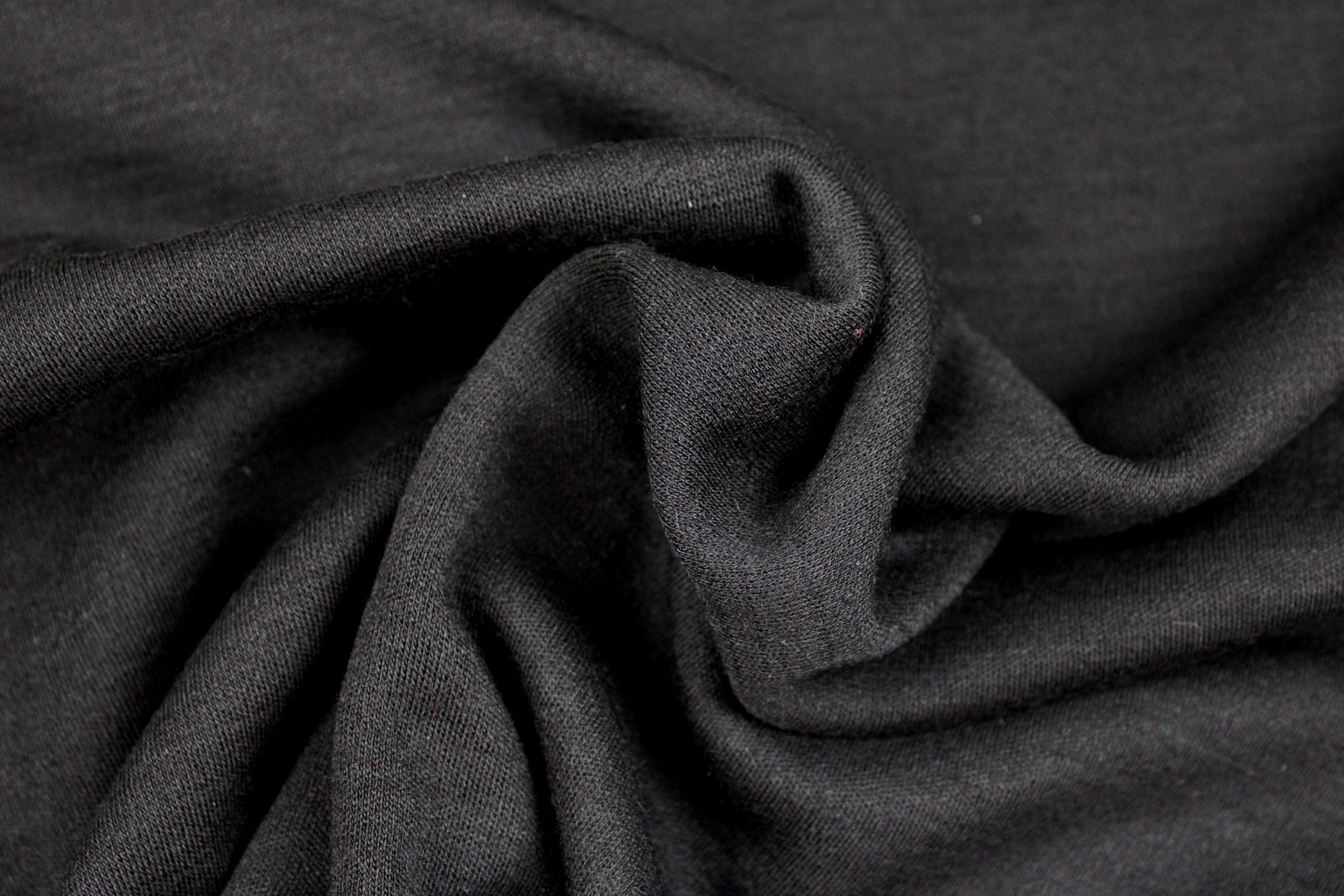 Merinostrickstoff Wolljersey in uni Schwarz gedreht