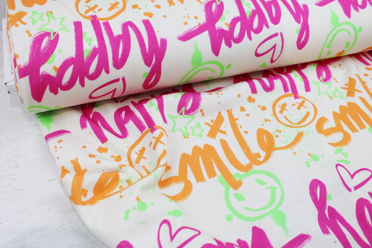 Heller Sweatstoff mit Graffitimuster in Neonfarben Ballenansicht
