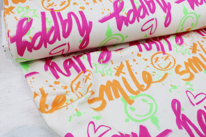 Heller Sweatstoff mit Graffitimuster in Neonfarben Ballenansicht