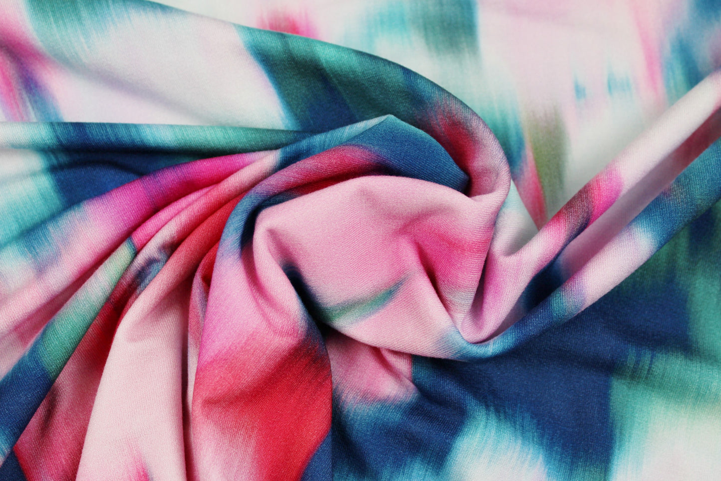 Viskosejersey Sizilien mit abstraktem Blumenmuster in Petrol und Pink gedreht