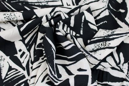Viskosestoff mit Blättermuster und Leinenstruktur in Schwarz und Wollweiß gedreht
